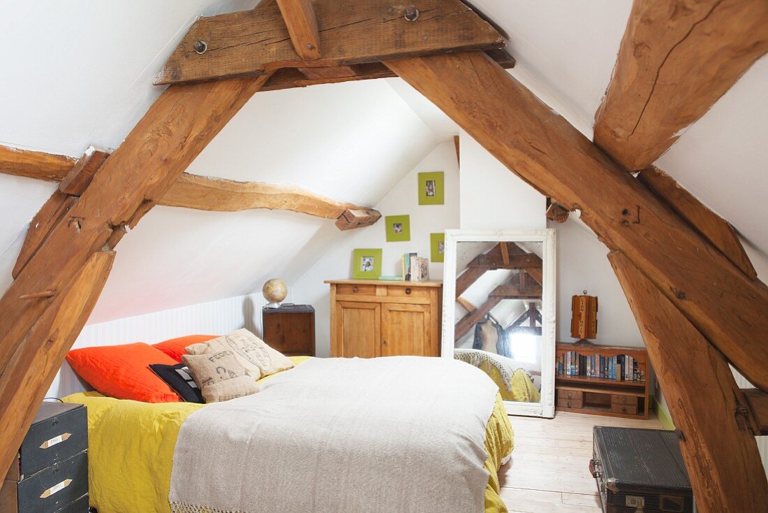 Rustic roof beams in attic bedroom