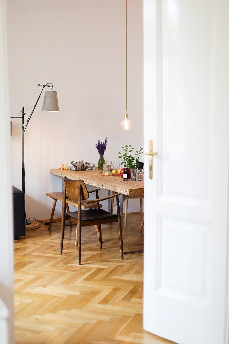 Vintage chair on herringbone parquet floor in dining room