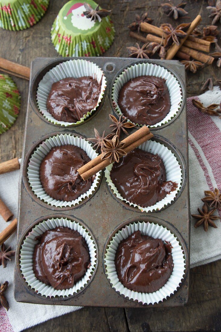 Unbaked chocolate muffins with cinnamon and star anise