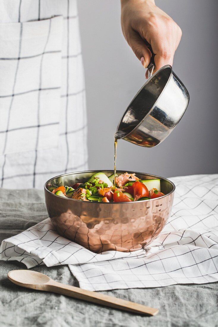 Zucchini and salmon salad drizzled with tomato vinaigrette