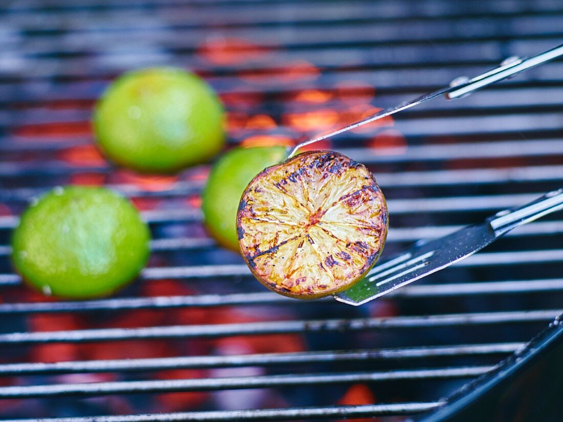 Lime halves being grilled on a barbecue