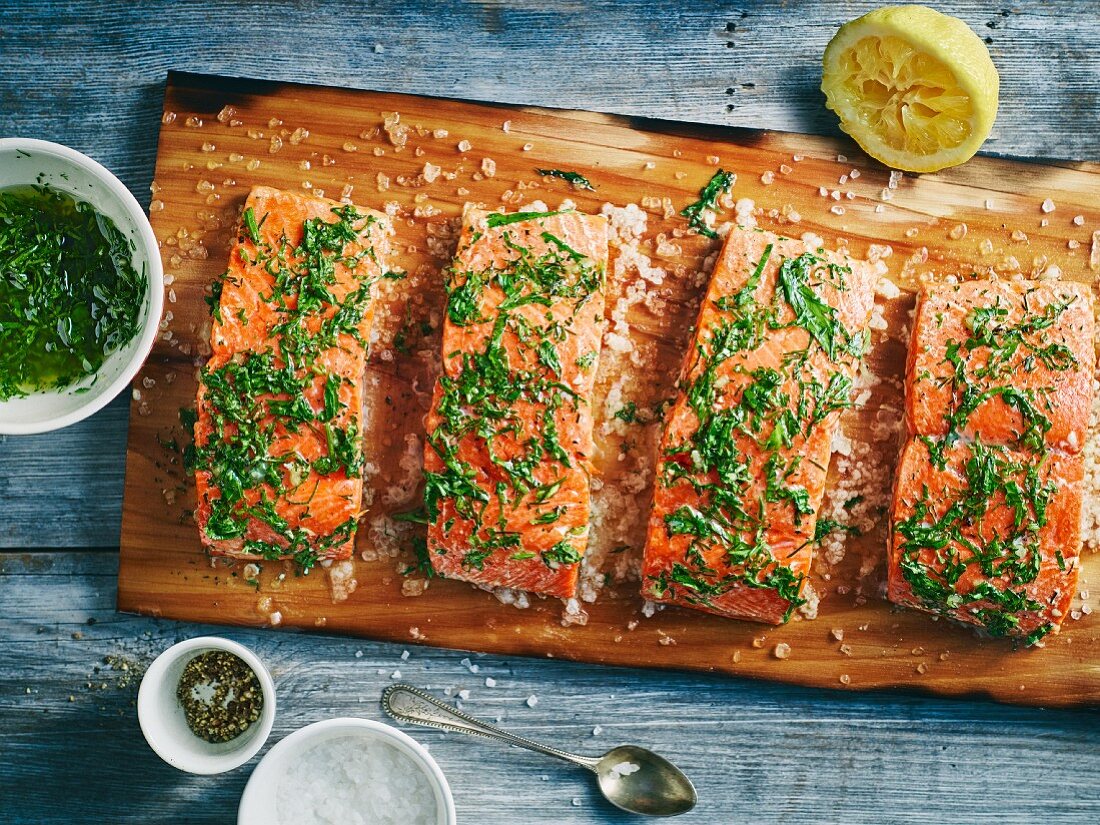 Herb salmon fillet with sea salt grilled on a plank