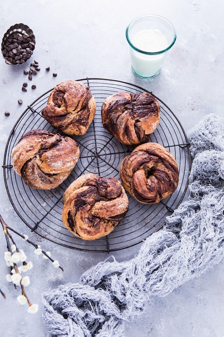 Chocolate pastry swirls on a wire rack