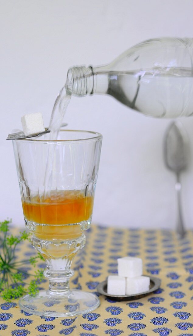 Water being added to a glass of apple vinegar