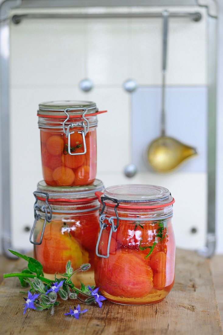 Preserved tomatoes in jars in a kitchen