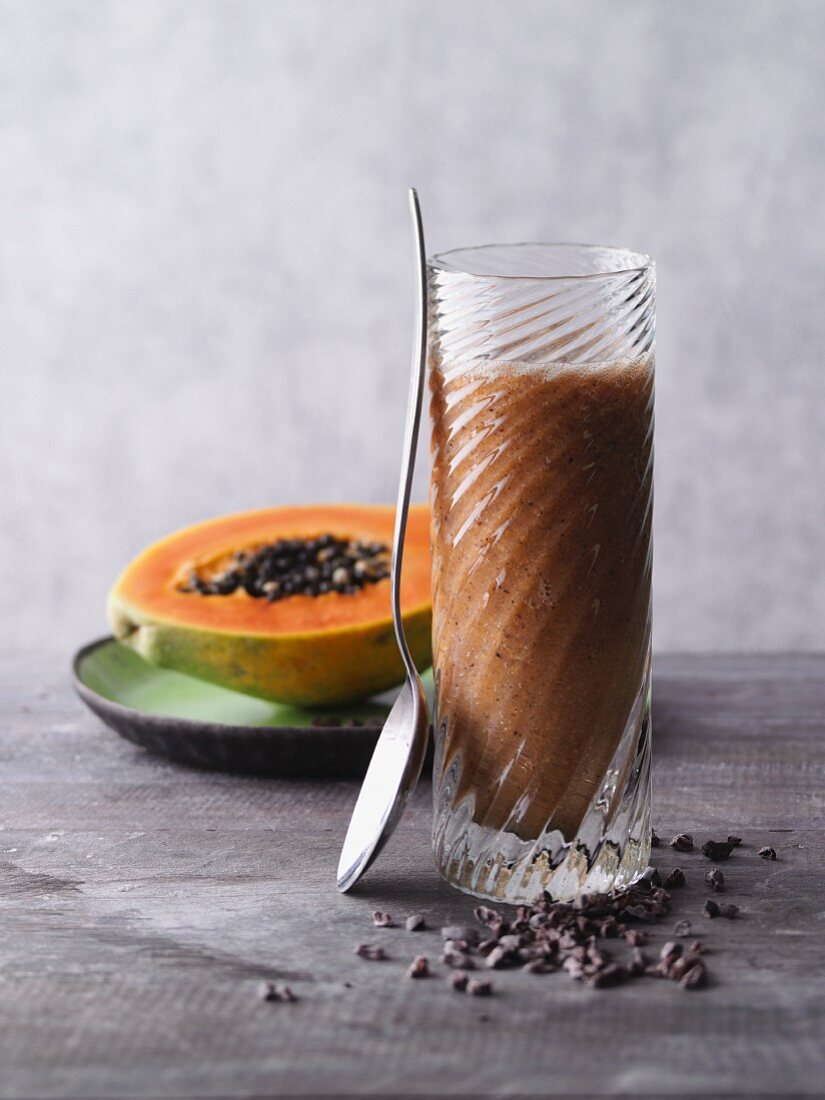 A pineapple and papaya smoothie with physalis and cocoa nibs