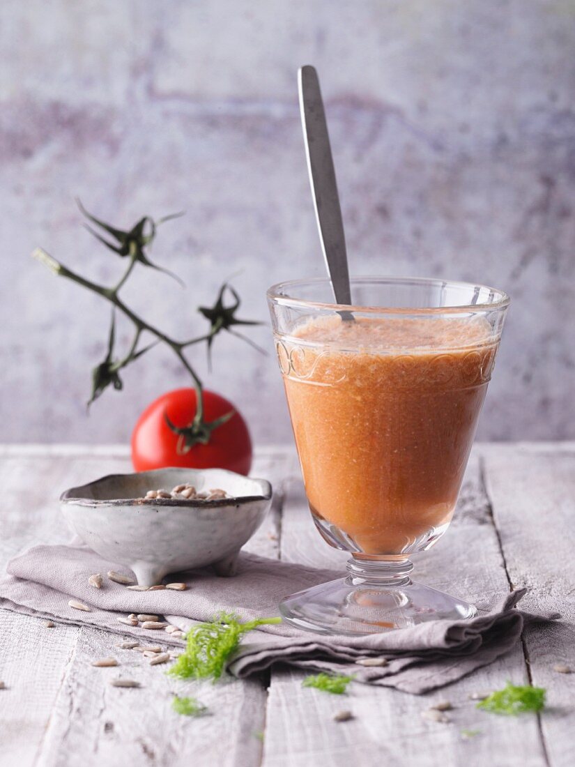 A tomato and pepper smoothie with red seaweed and sunflower seeds