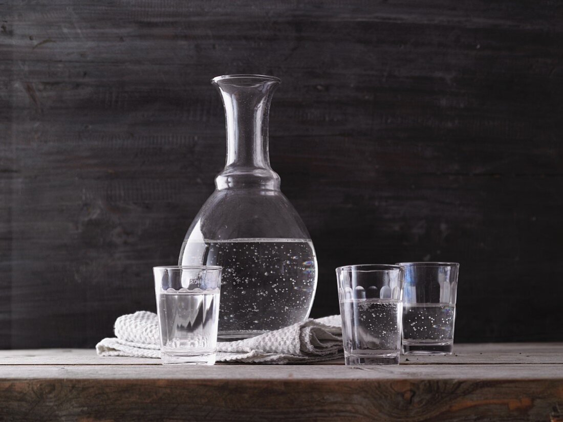 Water in a carafe and in drinking glasses