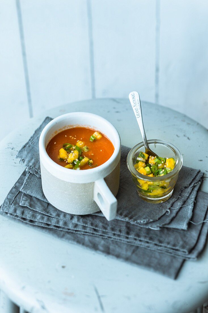 Spicy oven-roasted tomato soup with harissa and mango salsa