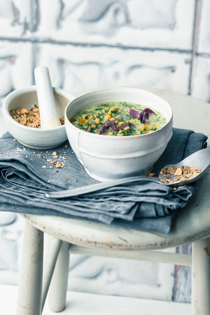 Kale and coconut soup with apricots and peanut and coconut sprinkles