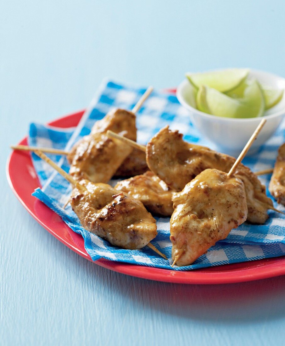 Chicken breast skewers with lime wedges