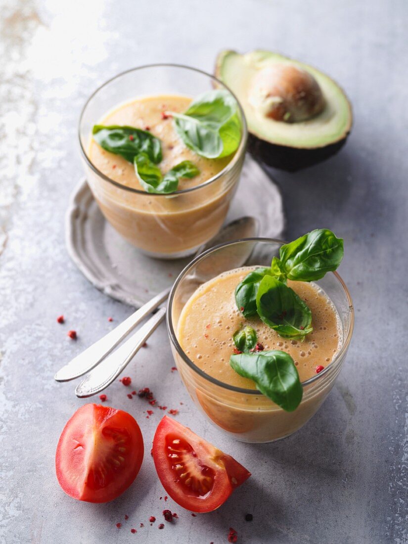 Tomato smoothies with avocado, basil and pepper