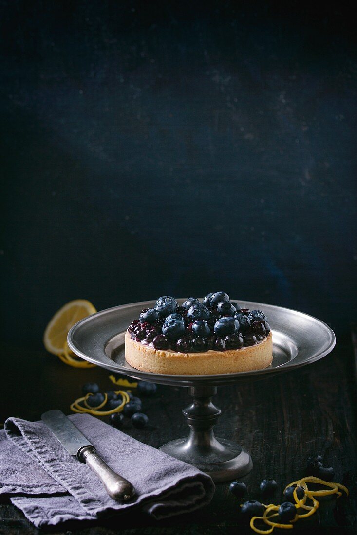 Blueberry and lemon tartlet on a cake stand