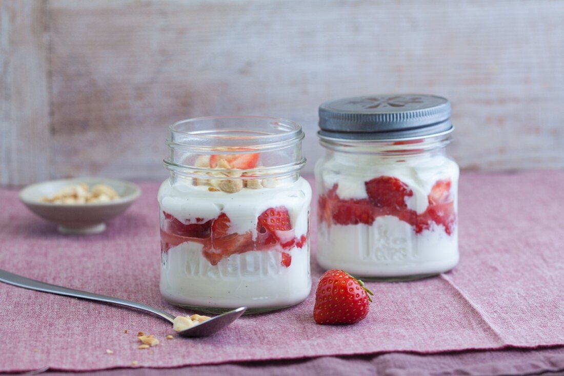 Strawberry and quark desserts with almonds in jars