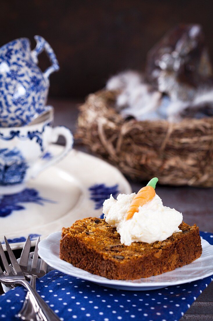 A slice of coconut, walnut and carrot cake with coconut cream and coconut flour sugar for Easter