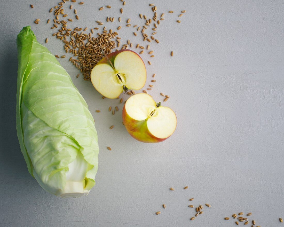 Grains, pointed cabbage and a halved apple