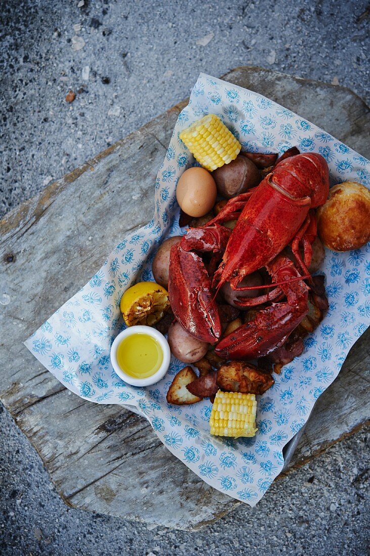 Cooked lobster with corn cobs and potatoes