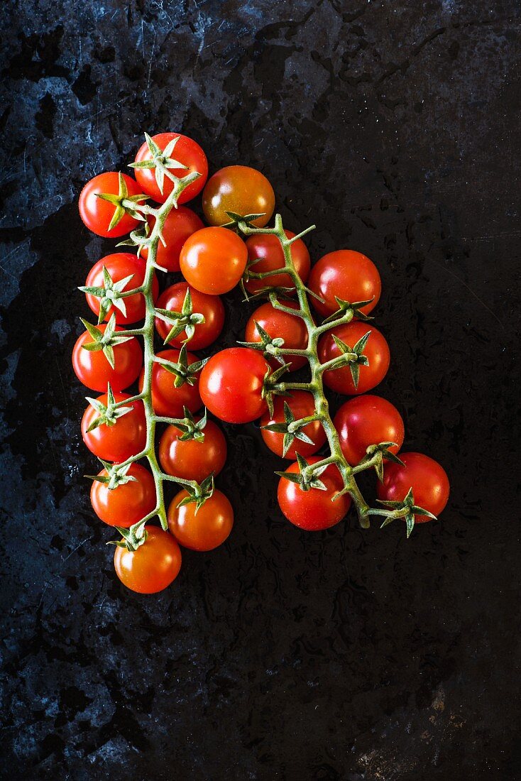 Vine tomatoes on a black surface