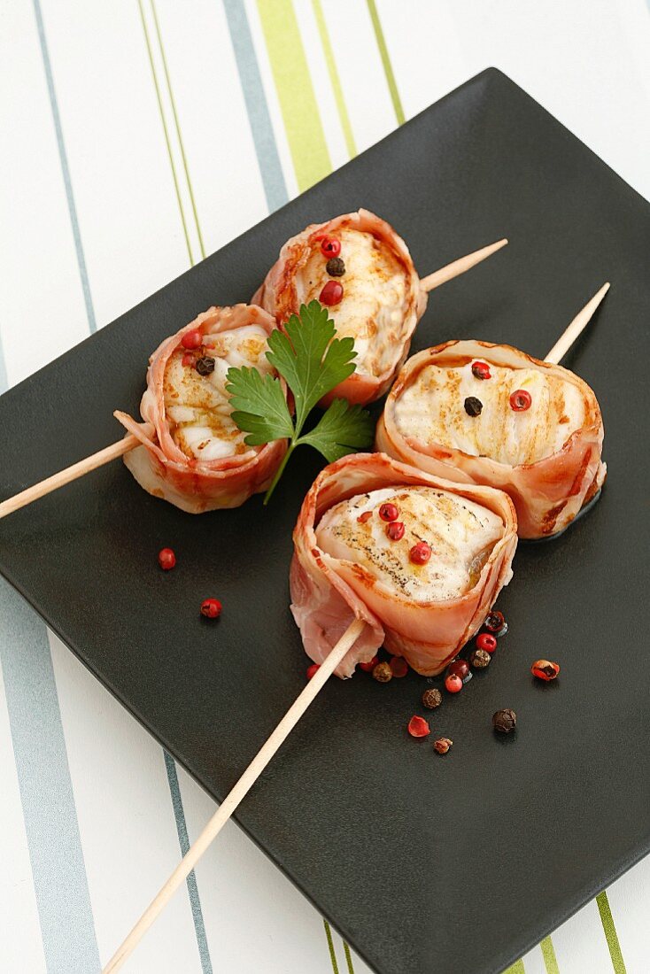Grilled fish skewers wrapped in bacon