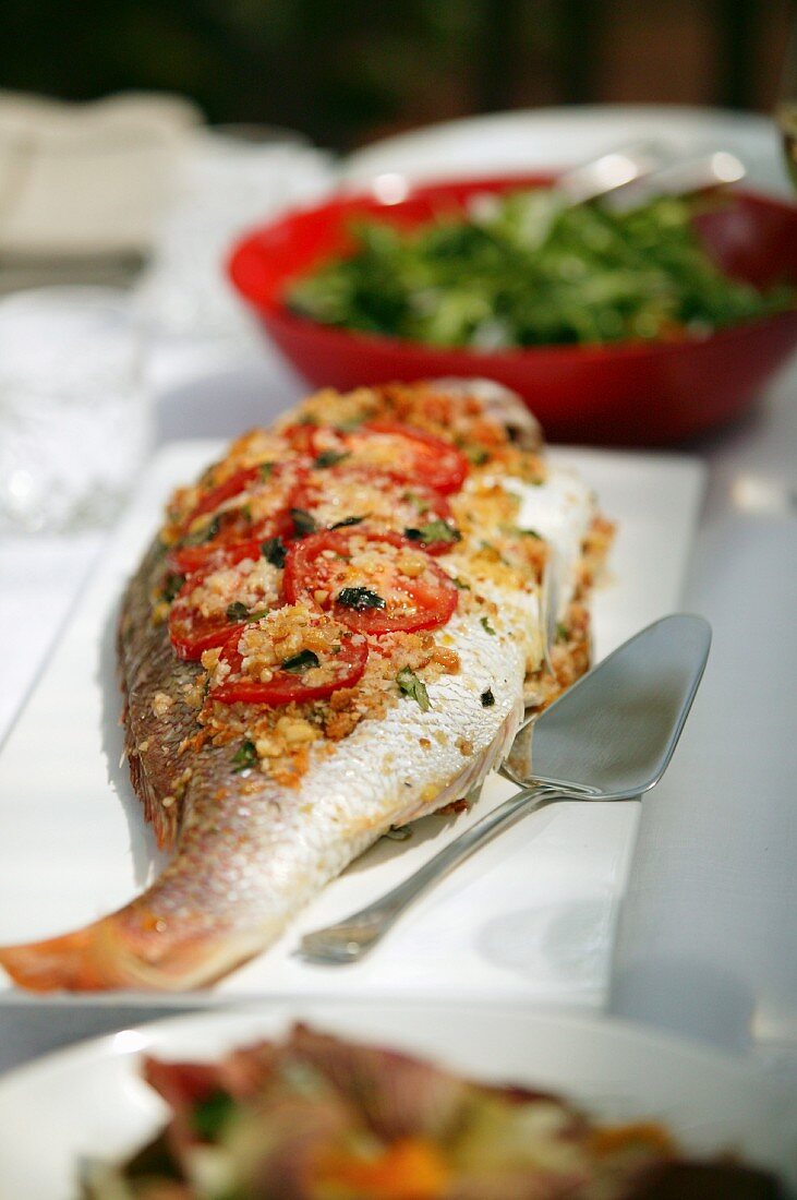 Baked Whole Fish with tomatoes & olives