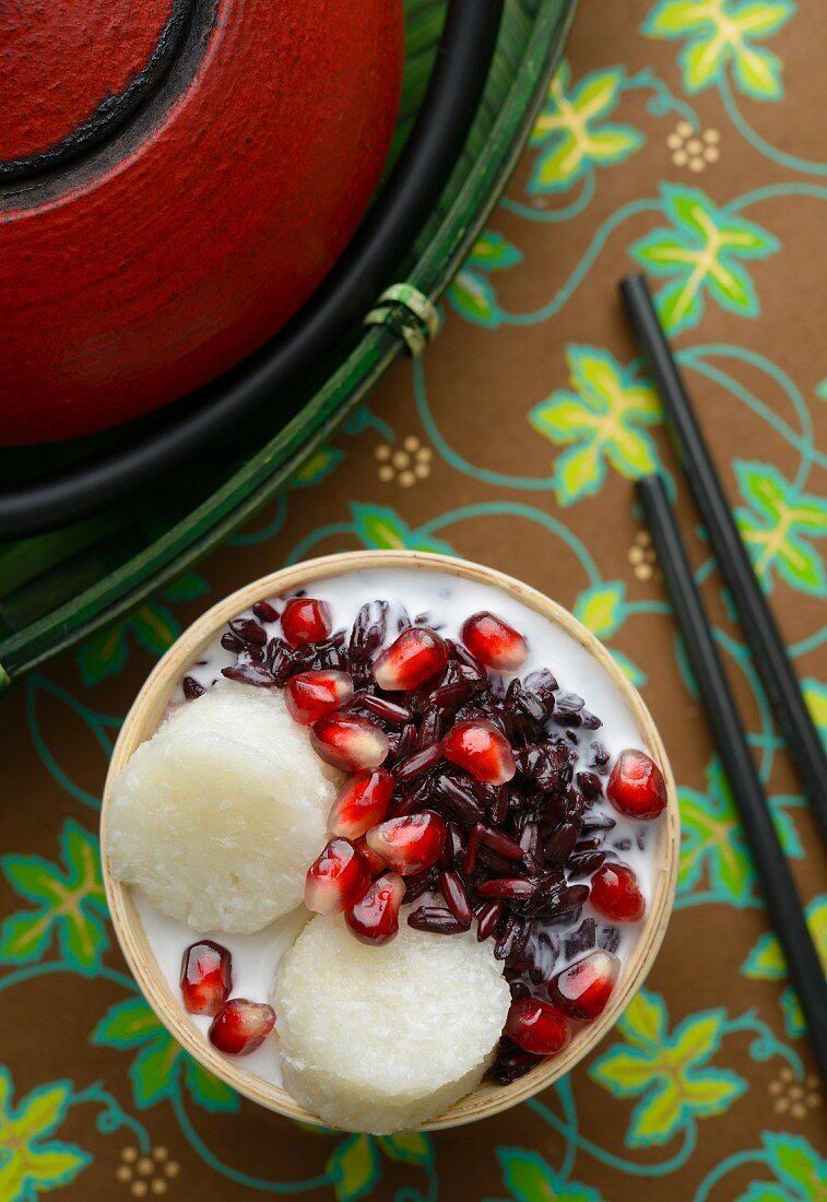 Tape Uli (sweet, fermented, black sticky rice with coconut milk, Indonesia) with pomegranate seeds