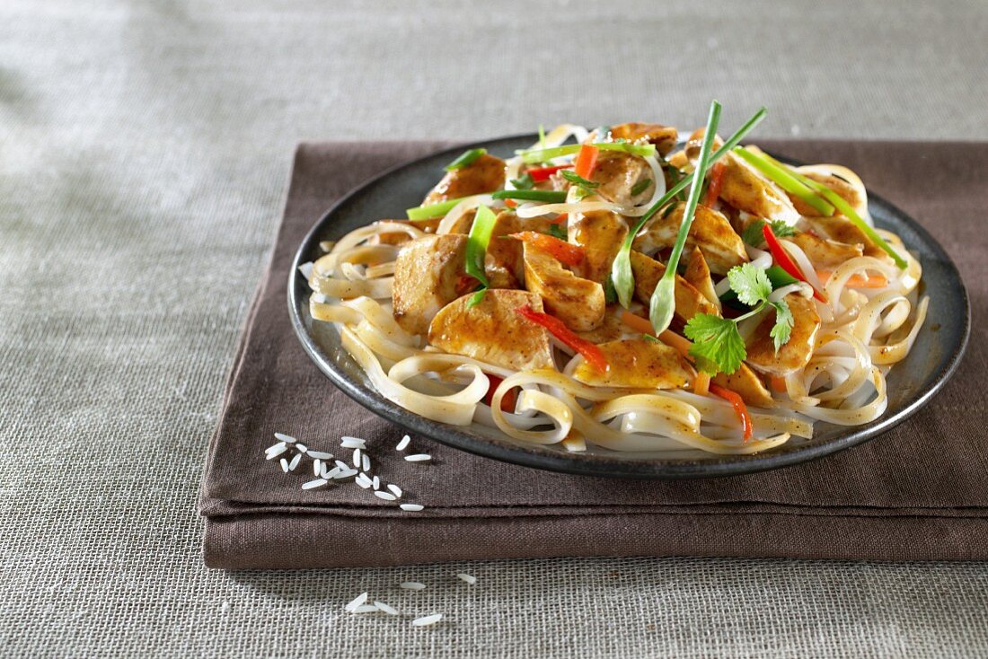 Thai-style chicken on a bed of rice noodles