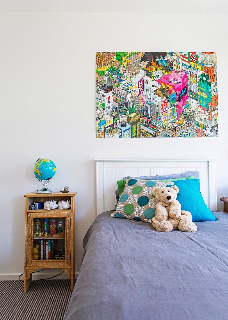 Boy's room with vintage bedside tables, illuminated globe and colorful comic poster over headboard