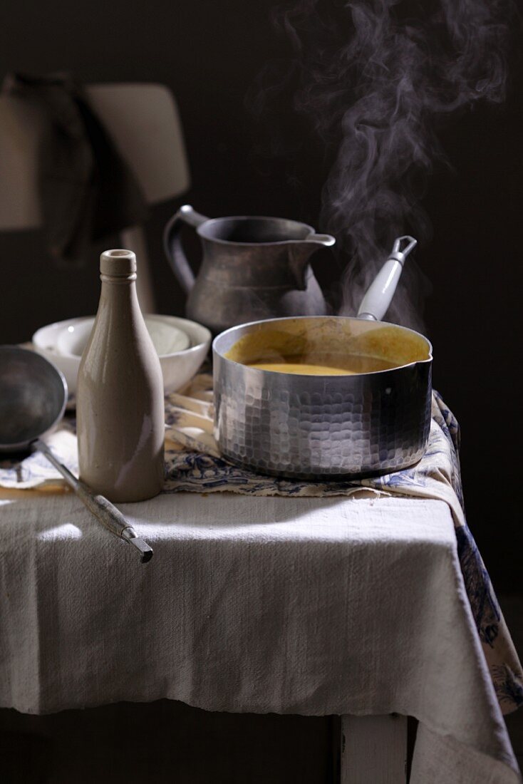 Steaming soup on a laid table