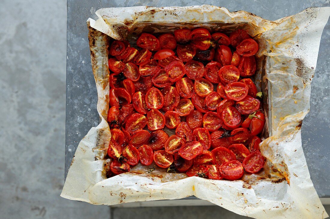 Oven-roasted cherry tomatoes on a baking tray