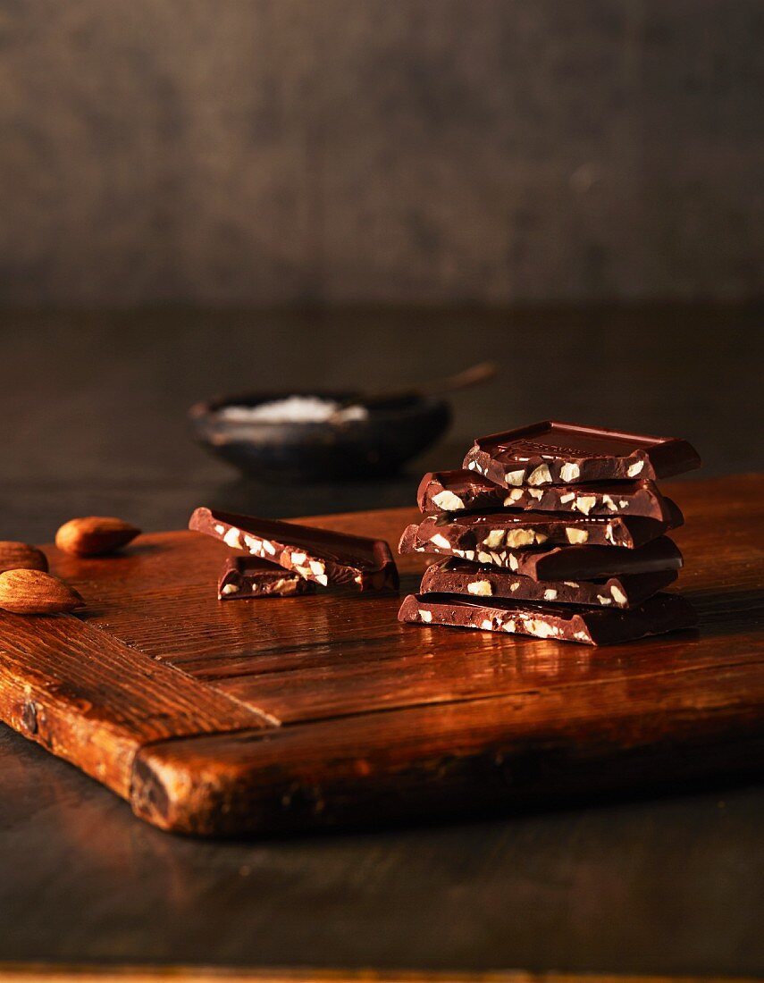 Pieces of almond chocolate on a wooden board