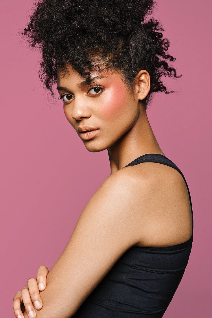 A young woman wearing a black tank top