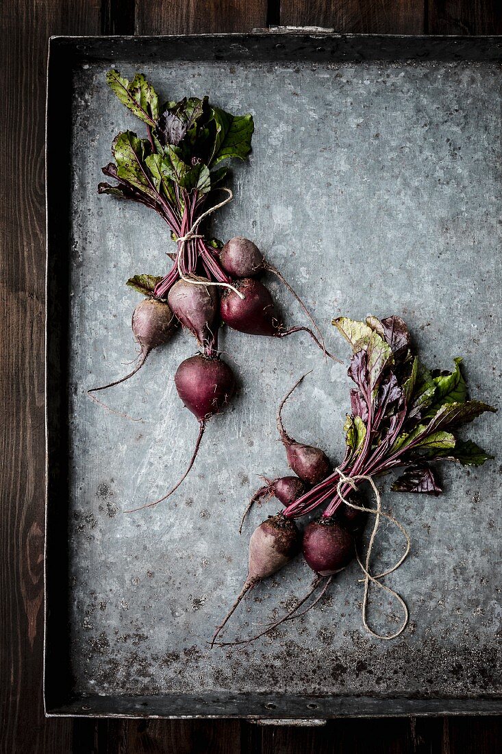 Bundles of beetroot on a baking tray