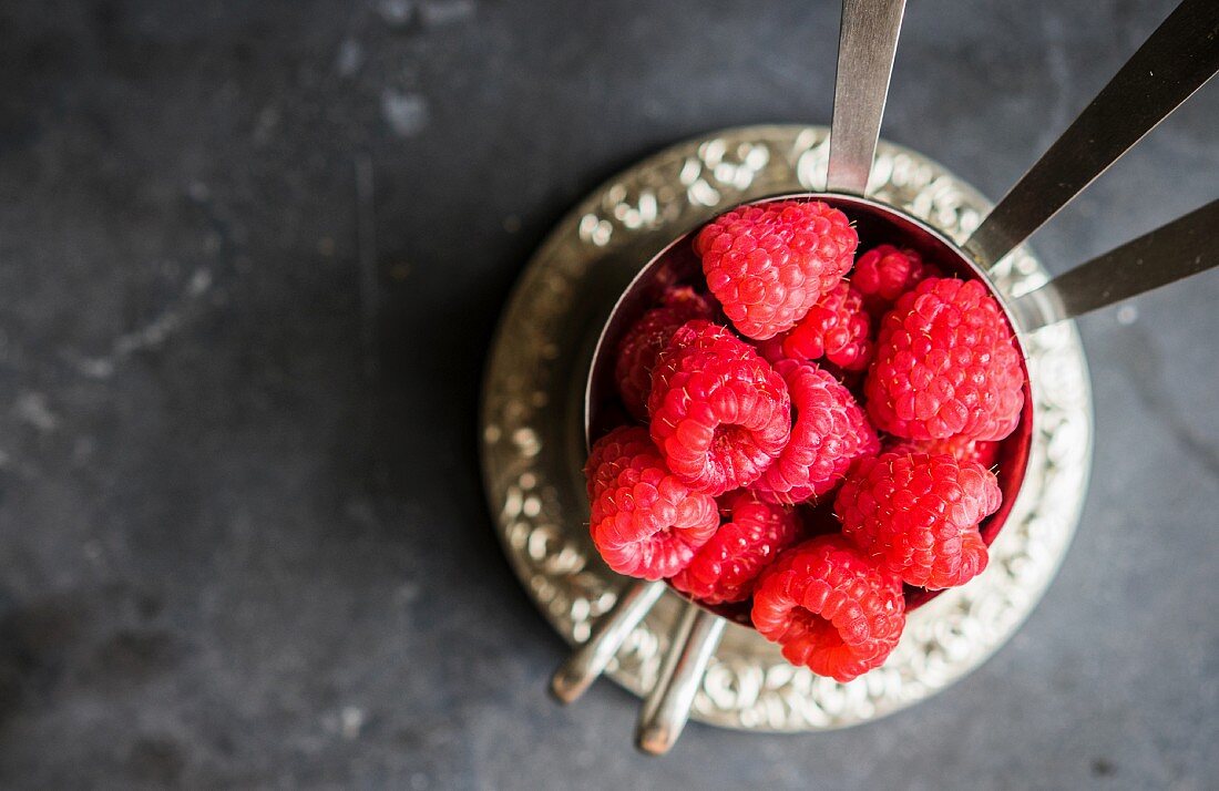 Fresh raspberries in silver cups