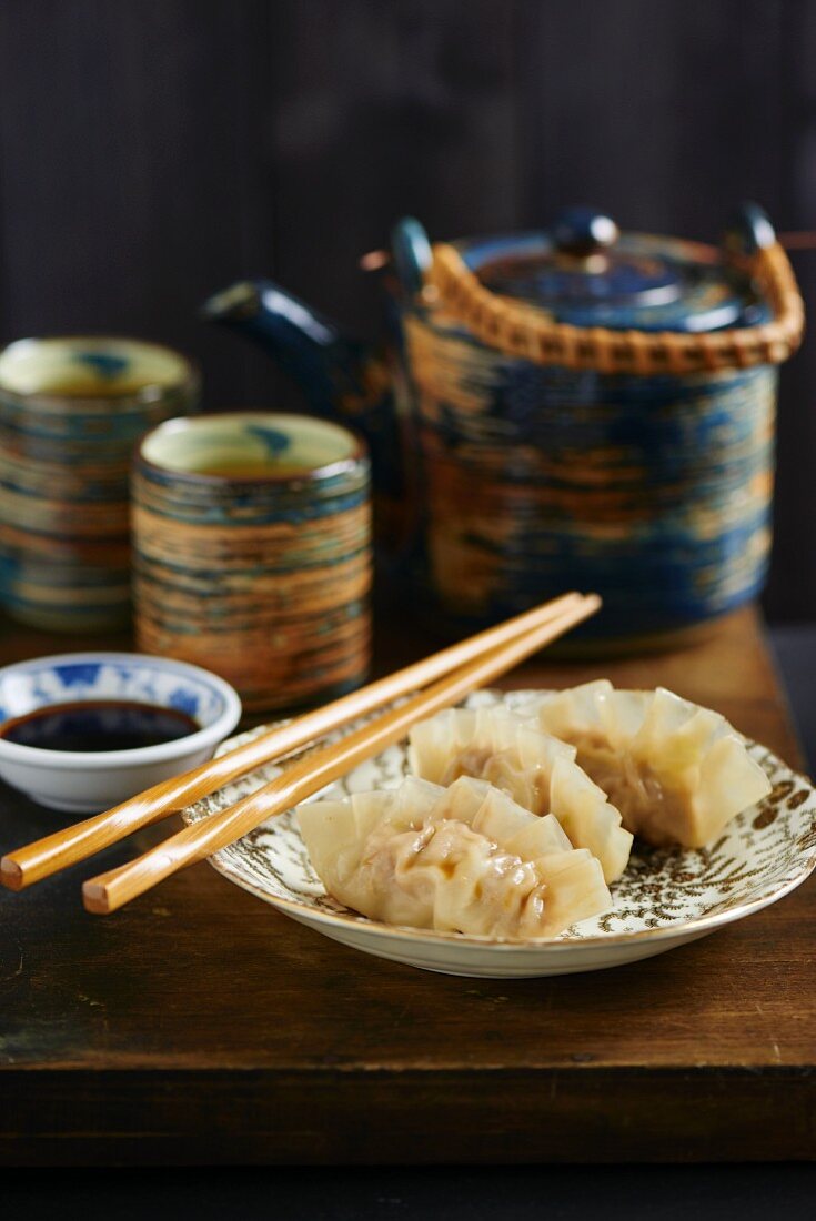 Gyoza with soy sauce served with tea