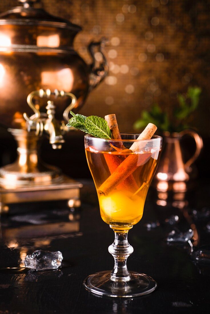 Alcohol-free, cold apple mulled wine with cinnamon sticks