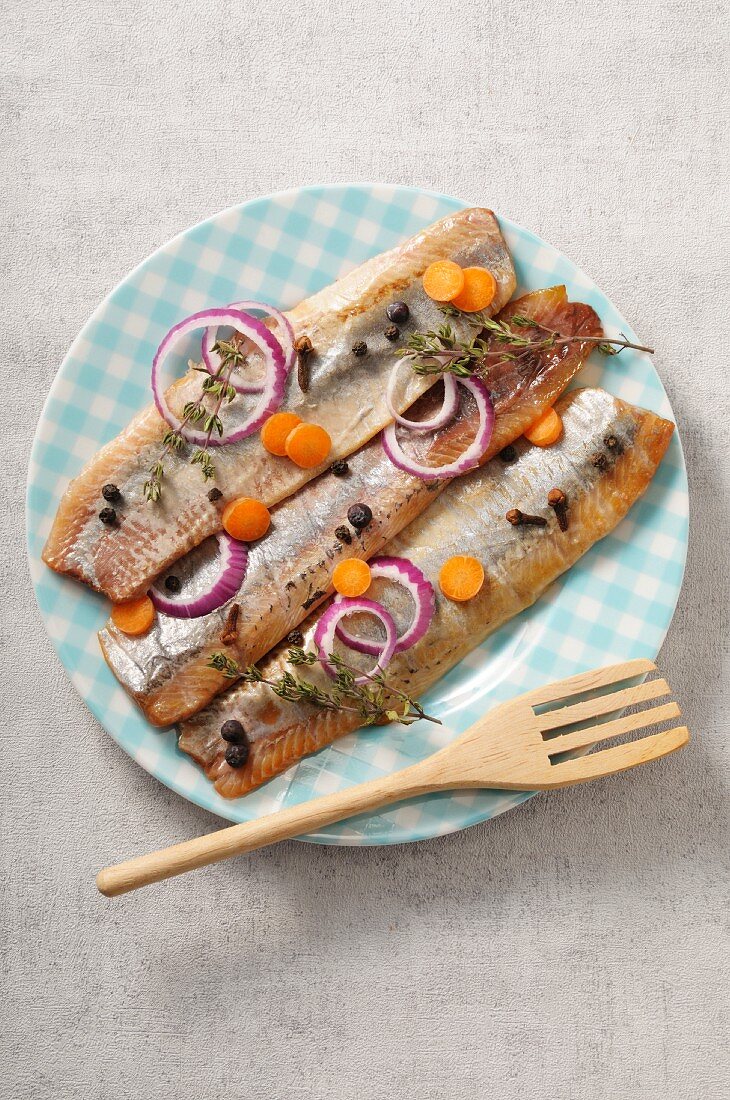 Pickled herring fillets with spices, onions and carrots