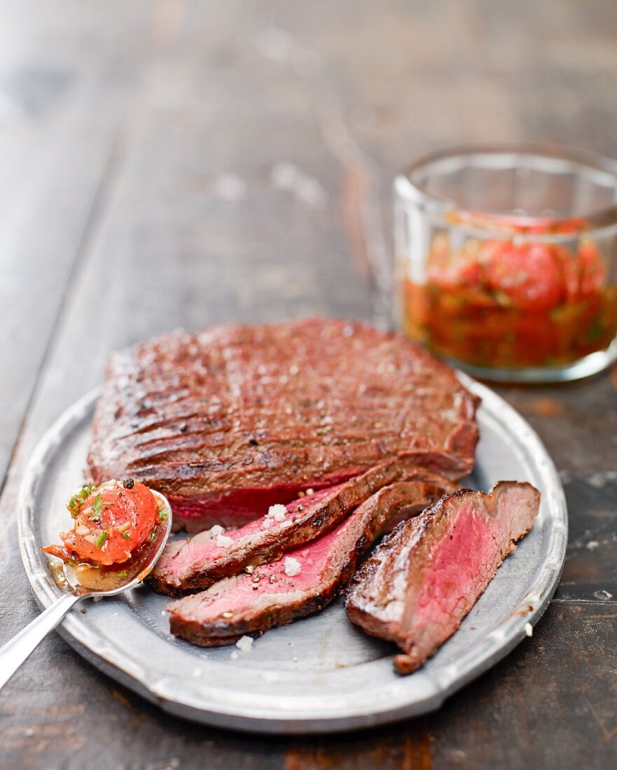 Grilled flank steak with a cherry tomato sauce
