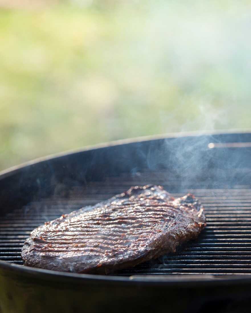 A flank steak on a barbecue