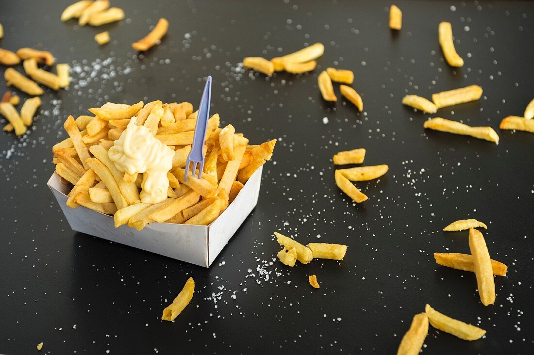 Chips in a paper dish with a chilli and honey mayonnaise