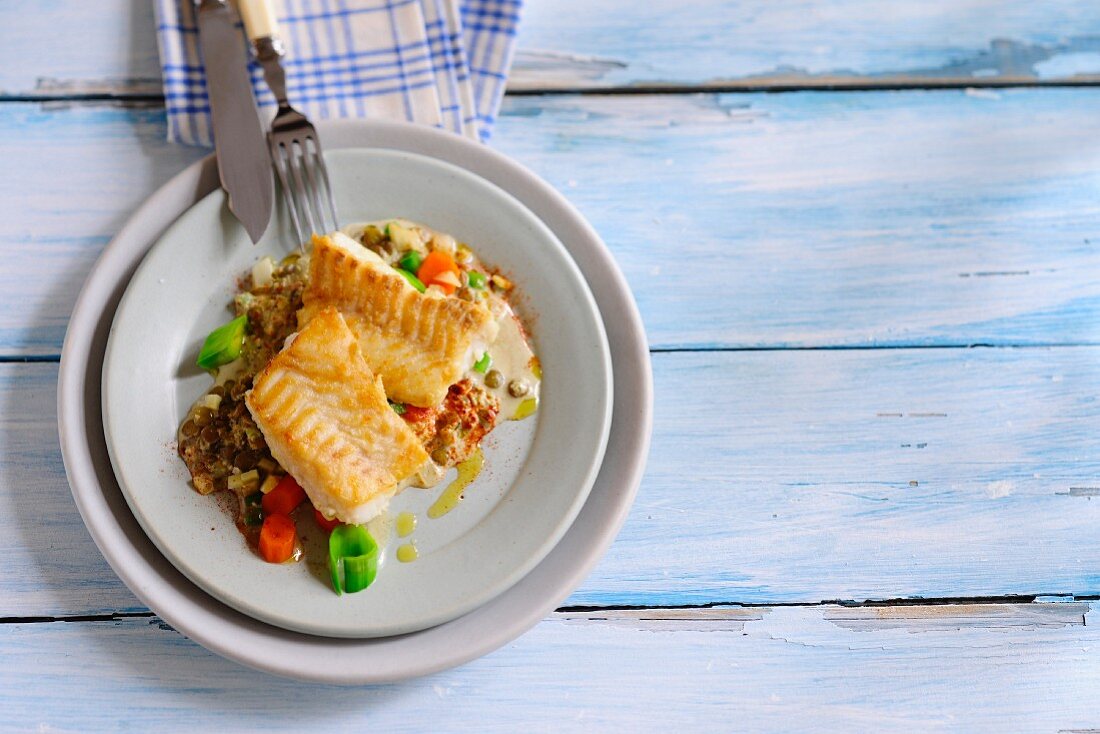 Fish fillets on a lentil medley