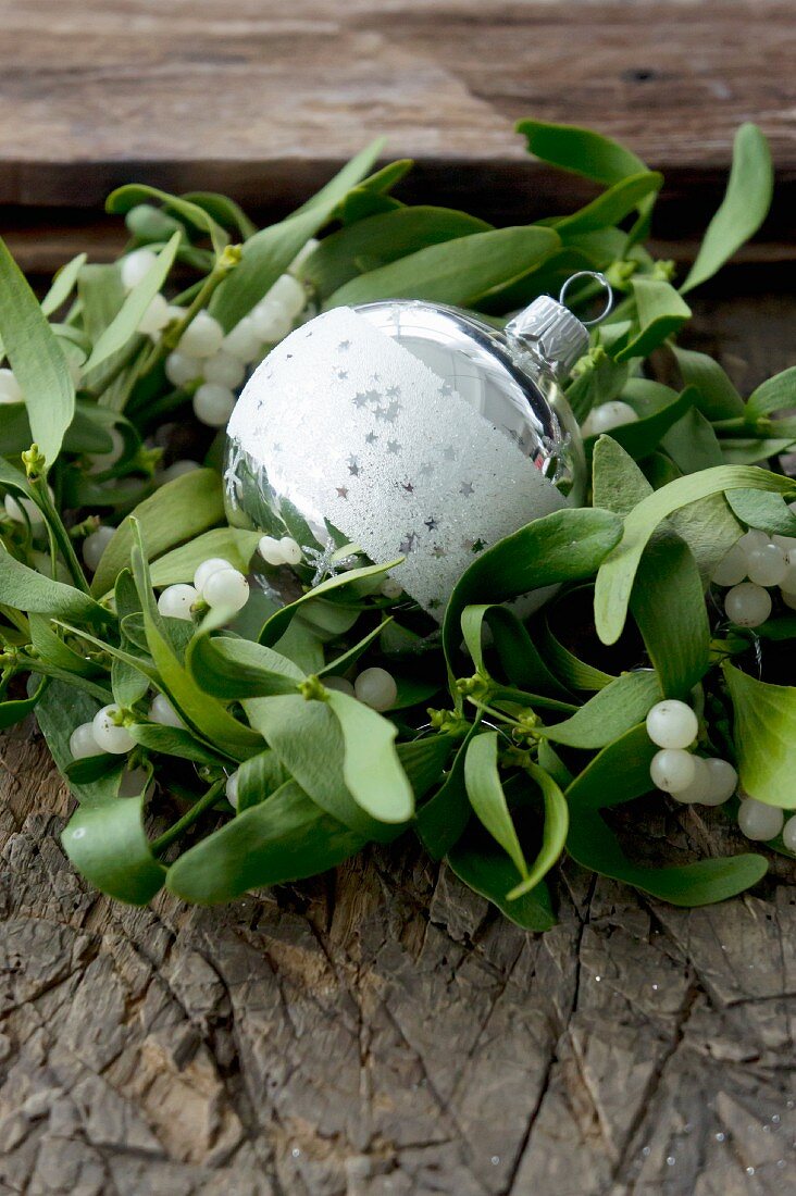 Wreath of mistletoe around Christmas tree bauble