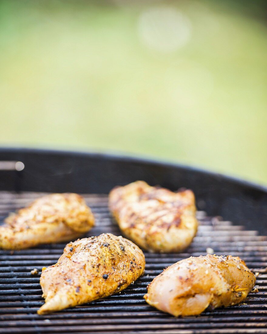 Stuffed Oriental-style chicken breasts on a barbecue