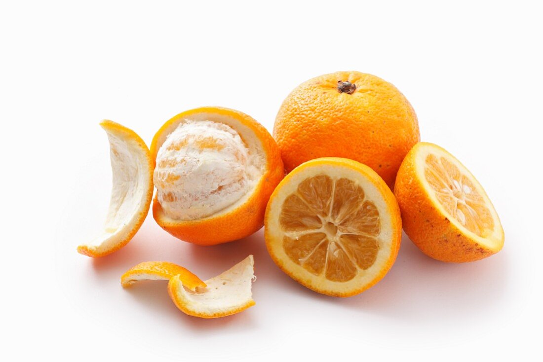 Bitter oranges, whole, halved and peeled