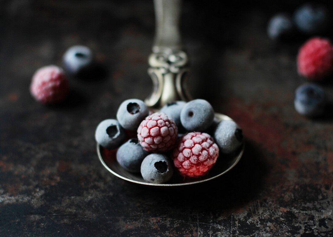 Frozen berries on a silver spoon