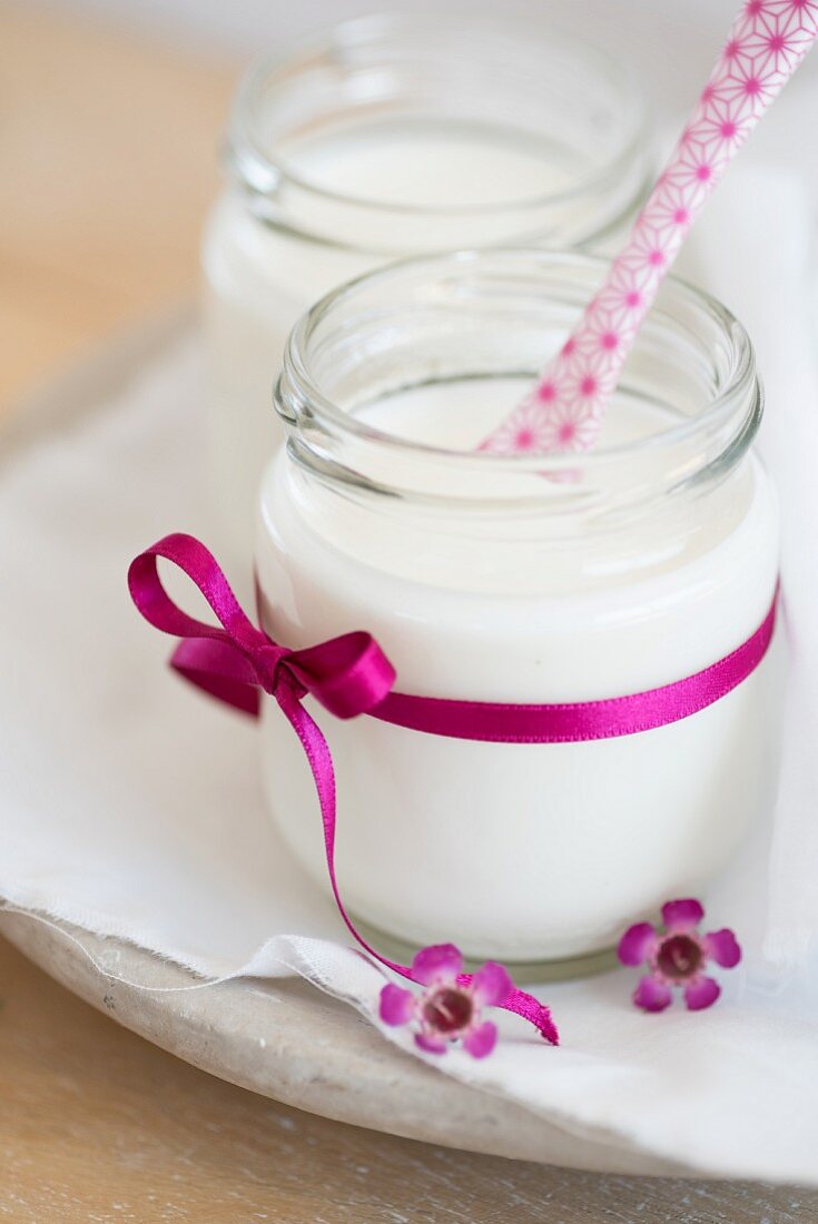 Homemade yoghurt in a jar with a pink bow