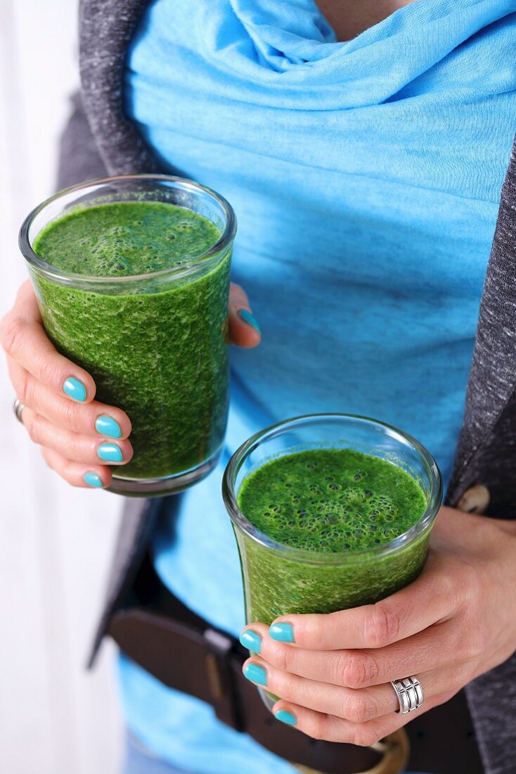 Glasses of spinach and cabbage smoothie with apple juice and chia seeds