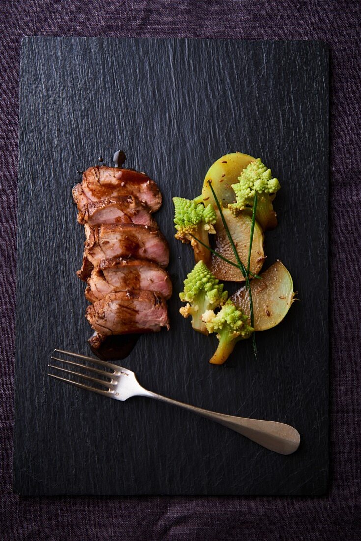 Filet mignon with Romanesco broccoli and kohlrabi on a slate platter