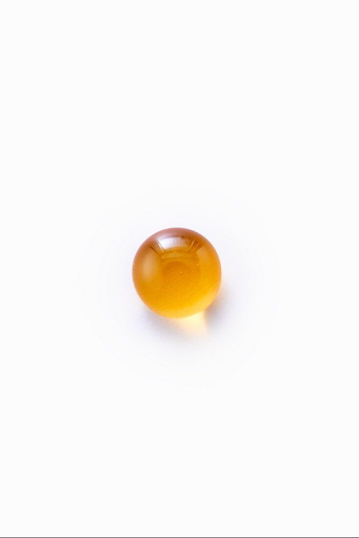 A drop of honey on a white surface