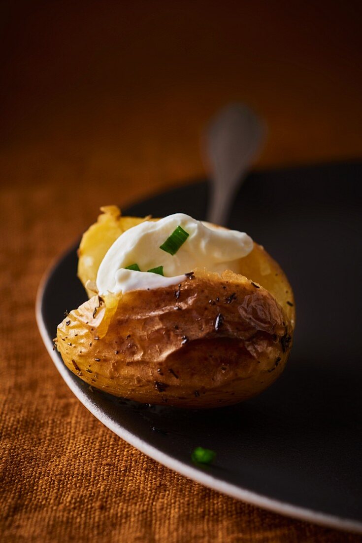 A baked potato with chive crème fraîche