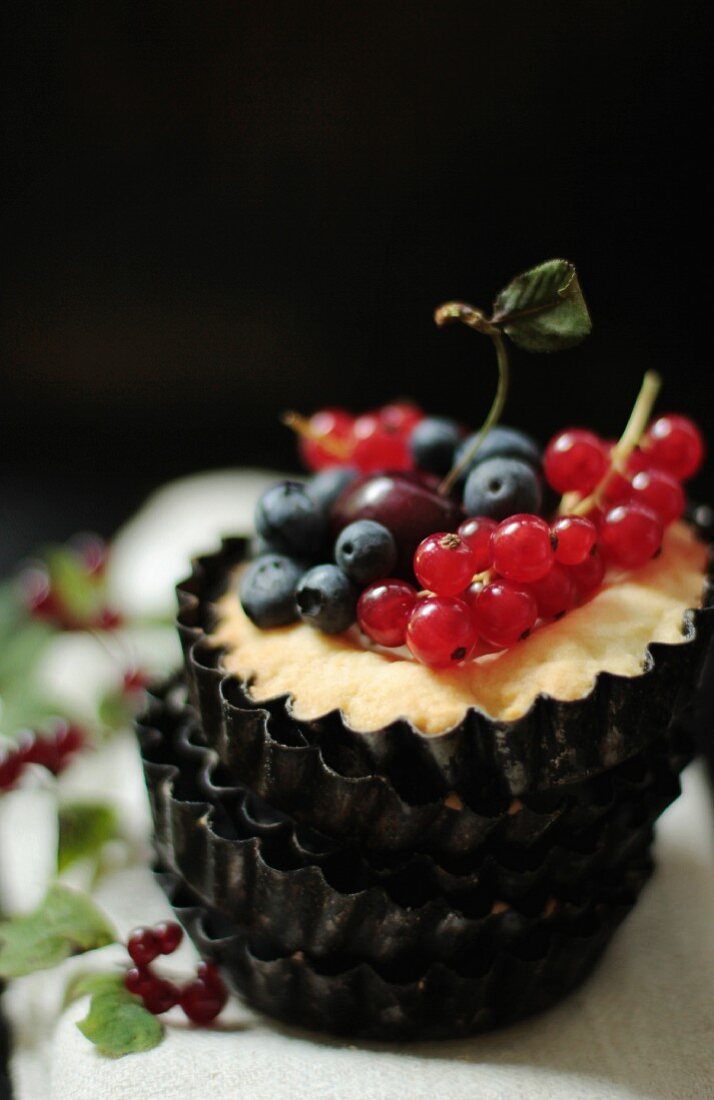 A tartlet with berries and a cherry
